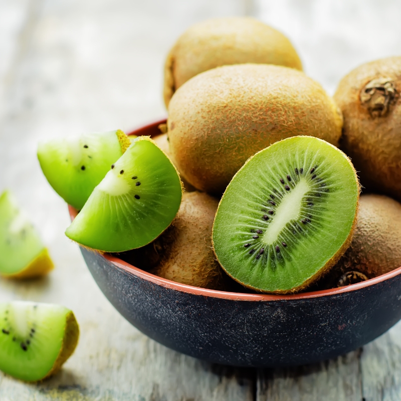 A close-up of fresh kiwi fruit with a bright green interior, highlighting its nutrients.